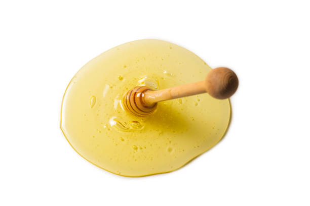 istock Dipper with honey on a white background. 1223366595