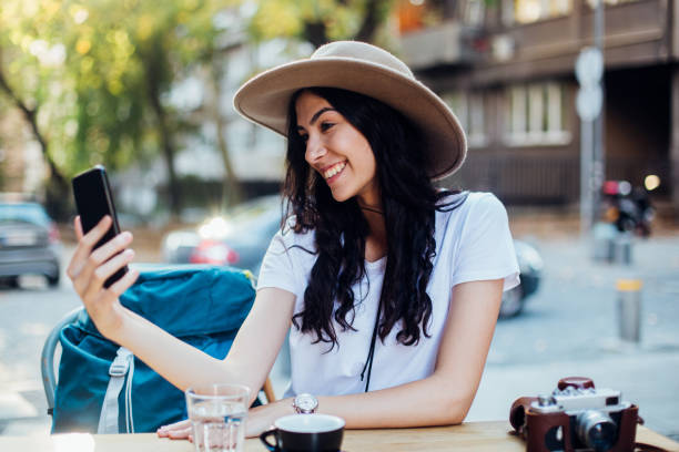 istock Girl on a journey having a break at the sidewalk cafe 1223366932