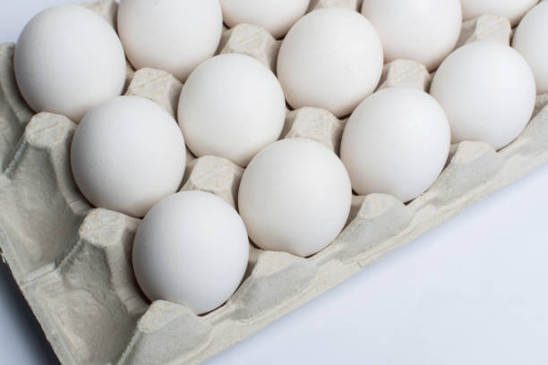 istock White chicken eggs in a cardboard box. Eggs in a paper tray. 1223369091