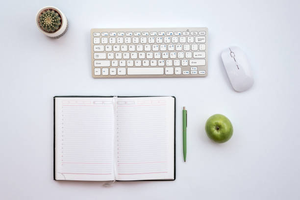 istock Top view office white desk with a mouse and keyboard. 1223371820