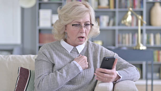 istock Sad Old Woman Facing Loss on Smartphone 1223373695