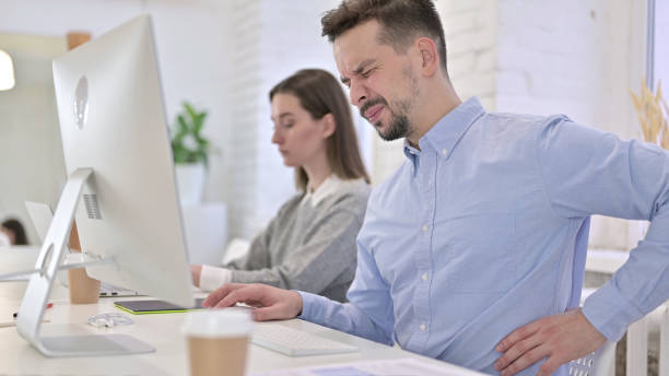 istock Tired Creative Man having Back Pain in Modern Office 1223373807