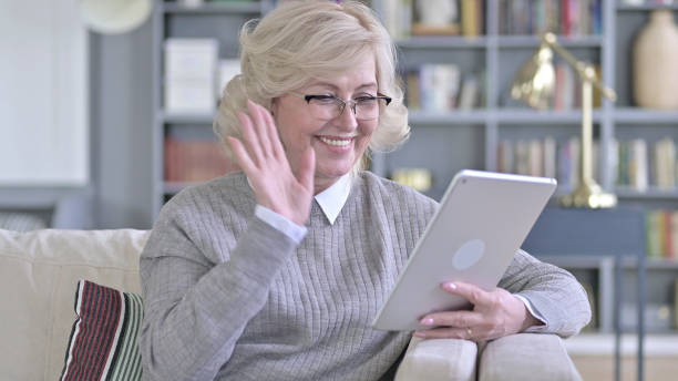 istock Old Woman doing Video Chat on Tablet 1223373882