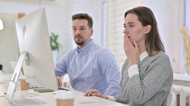 istock Shocked Creative Team Reacting to Failure on Desktop in Office 1223373906