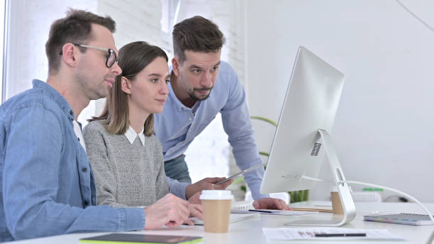 istock Angry Creative Professional Discussing with Team and Working on Desktop 1223374150