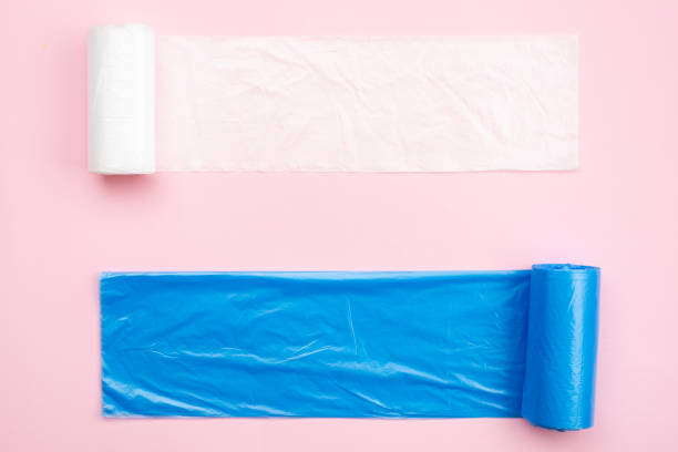 New white and blue garbage bags on a pink background.