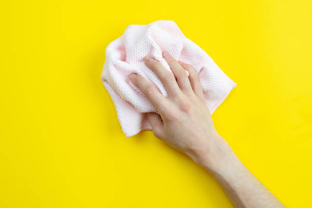 istock On a yellow background a hand holds a rag. Cleaning concept. 1223374213