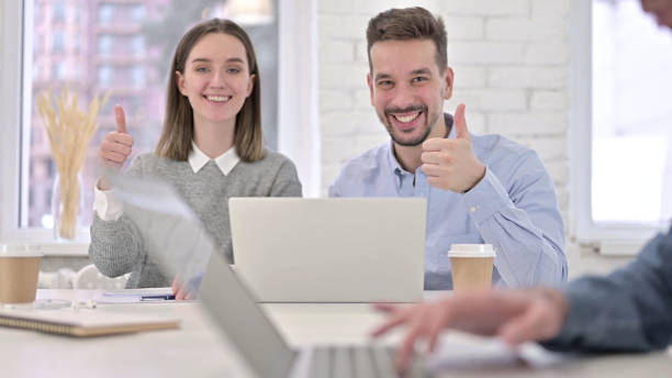 istock Ambitious Creative Team showing Thumbs Up in Office 1223374934