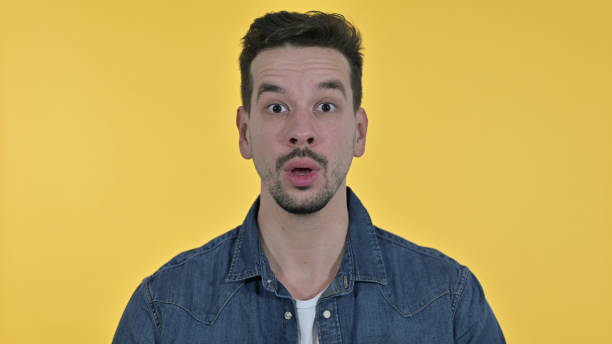istock Disappointed Young Man Reacting to Failure, Yellow Background 1223375762