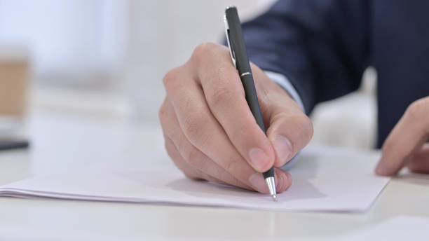 istock Businessman Writing on Paper, Close Up 1223375894