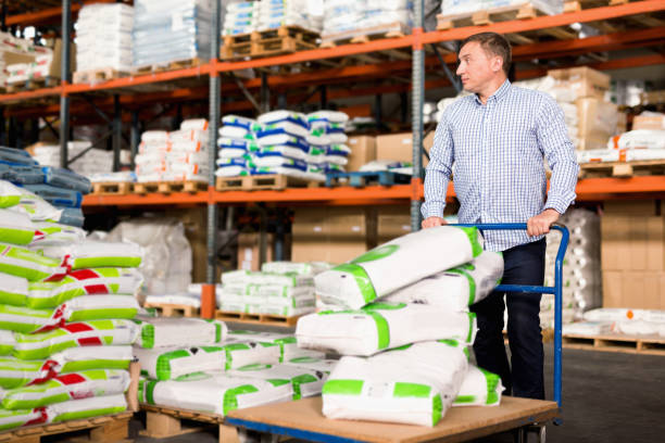 istock Man choosing compost soil in plastic bags in hypermarket 1223375949