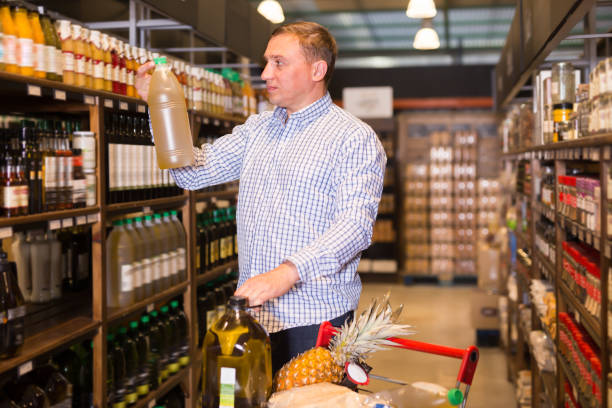 istock Positive male customer choosing olive oil 1223376513