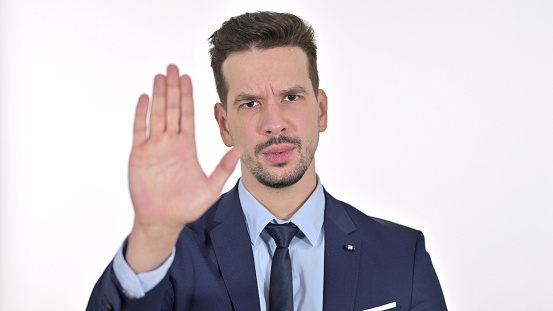 Young Businessman showing Stop Sign by Hand , White Background