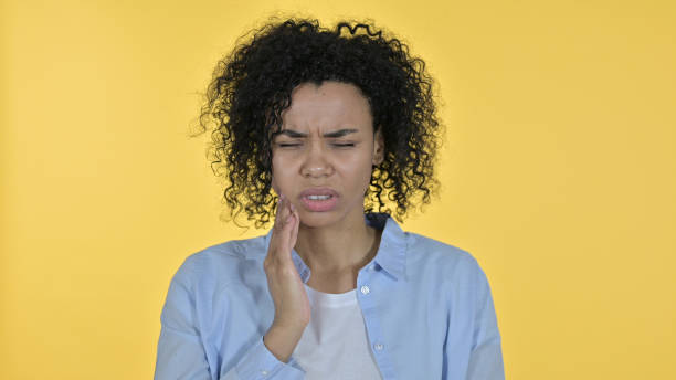 istock African Woman having Toothache, Yellow Background 1223376790