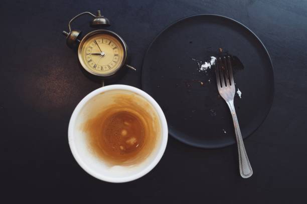 istock alram clock with empty a cup of cofee with frok and dish. 1223376905