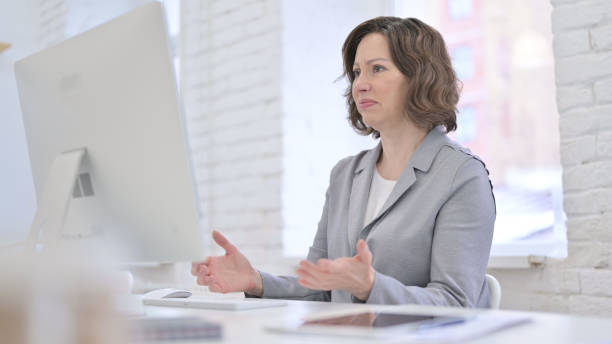 istock Creative Old Woman get Upset on Desktop 1223377234