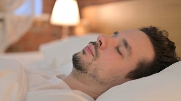 istock Close Up of Young Man Sleeping in Bed 1223377501