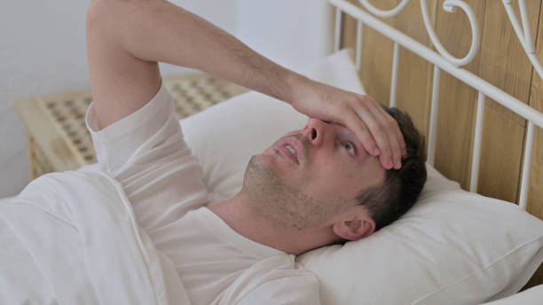 istock Scared Young Man Waking up from Nightmare in Bed 1223378593