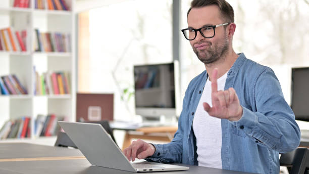 istock Young Man in Glasses saying No with Head Sign 1223380399