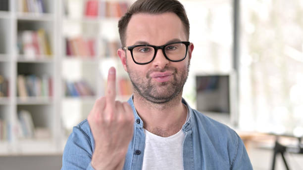 istock Young Man in Glasses showing Middle finger 1223380546