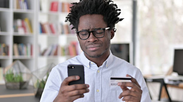 istock Online Payment Failure on Smartphone for Upset African Man 1223380684