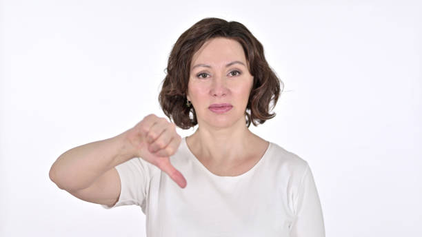 istock Thumbs Down by Disappointed Old Woman, White Background 1223380772