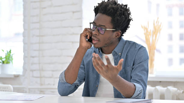 istock Ambitious Young African Man talking on Smartphone 1223380980