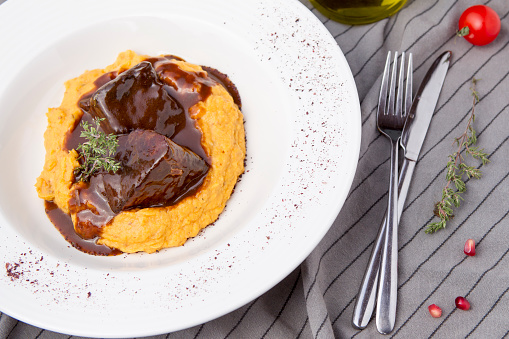 Delicious slow-cooked veal with pumpkin puree and brown sauce.