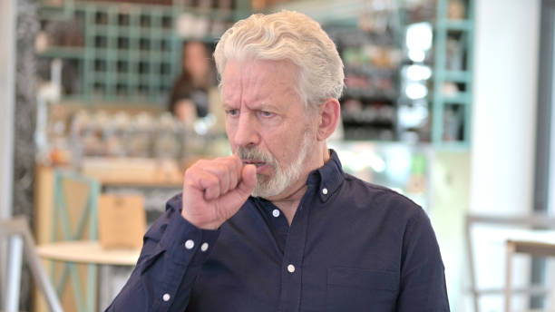 istock Portrait of Sick Old Man Coughing 1223381287