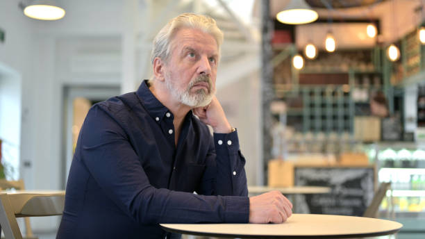 istock Pensive Old Man Thinking, Sitting in Cafe 1223381458