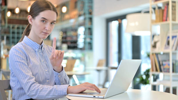 istock No Sign by Woman using Laptop in Cafe 1223381486