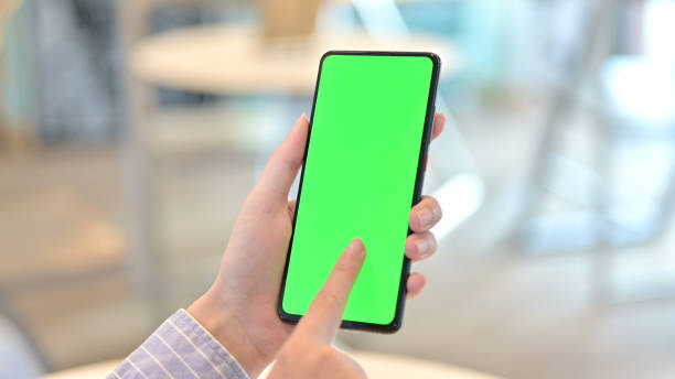 istock Rear View of Female Hand using Smartphone with Chroma Screen 1223381603