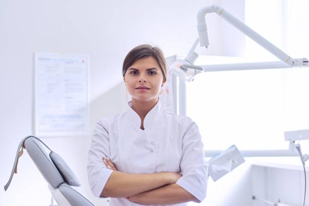 istock Young positive female dentist doctor with folded arms 1223381682