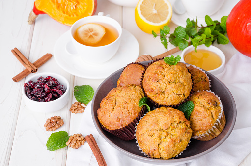 spiced pumpkin muffins with walnuts and cranberries.