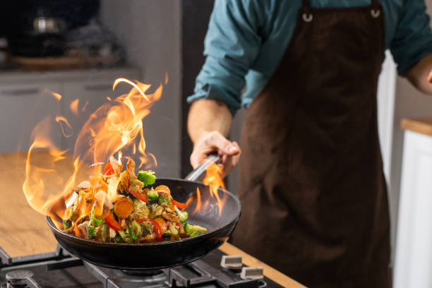 istock Chef frying vegetables in a pan 1223384029