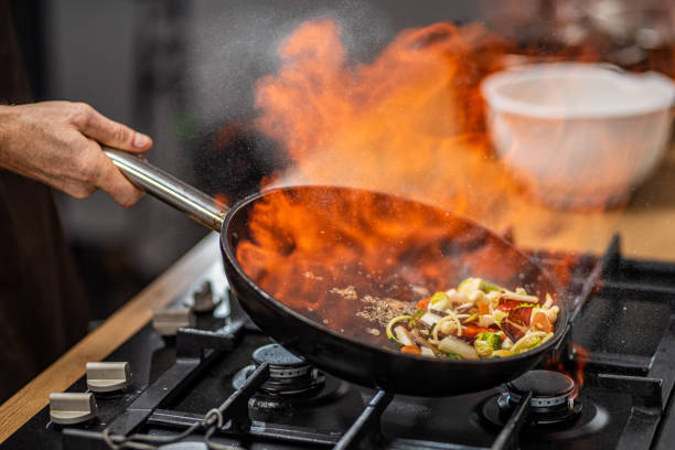 istock Chef tossing flaming vegetable 1223384044