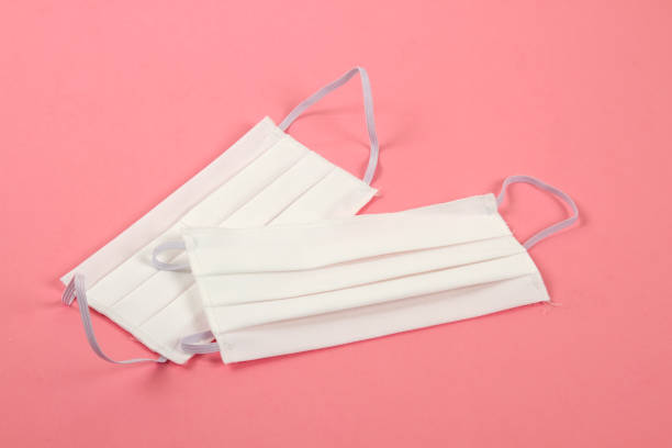 istock washable cotton protective mask pink background 1223385517