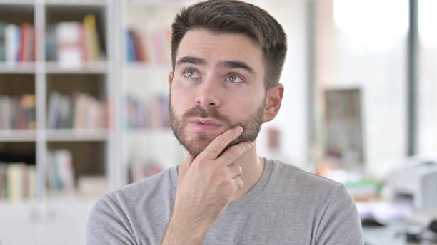 istock Portrait of Pensive Young Man Thinking New Idea 1223385565