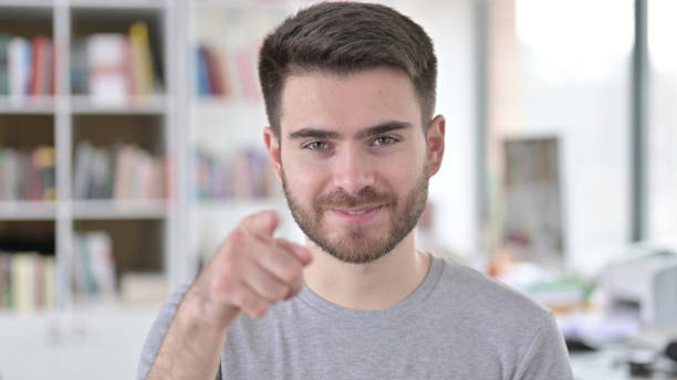 istock Portrait of Attractive Young Man Pointing at Camera 1223385757