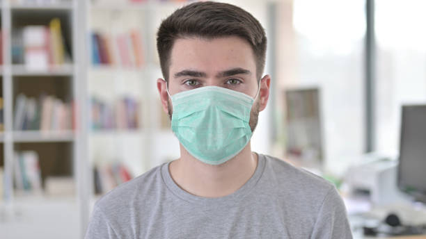 istock Portrait of Young Man in Protective Face Mask 1223385866