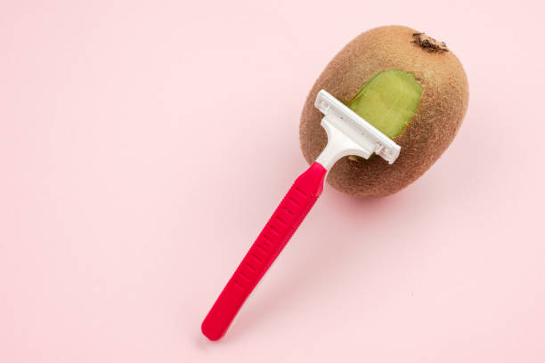 Kiwi Fruit And Razor On Pink Background Hair Removal Concept