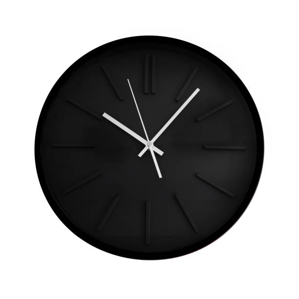 istock A deep black wall clock with silver metal hands, cut out on white background 1223386215