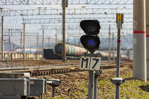 Vladivostok, RUssia - April,26,2020: Blue signal of a railway semaphore at a freight station in a suburb of Vladivostok.