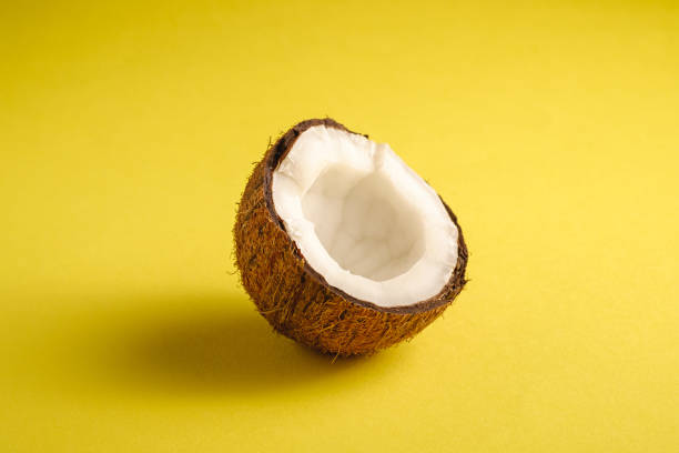 istock Single coconut fruit on yellow plain background, abstract food tropical concept, angle view macro 1223387402