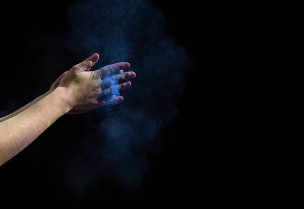 istock Hands clap with blue paint on black background 1223387515