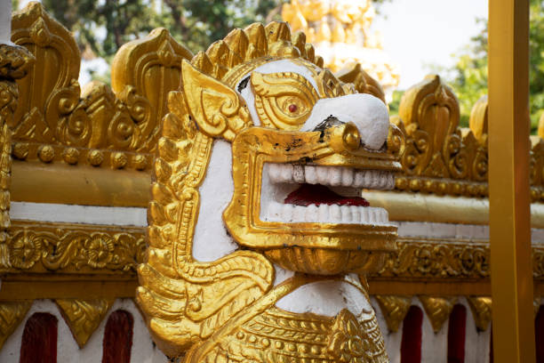 Golden singha statue guardian of Pagoda or Stupa of Wat Phra That Phanom temple for foreign traveler and thai people travel visit and respect praying in Nakhon Phanom, Thailand