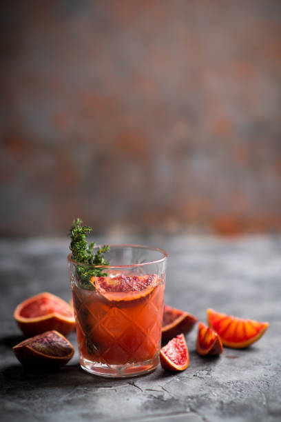 istock Old-fashioned cocktail with blood oranges and thyme on the rustic background 1223389011