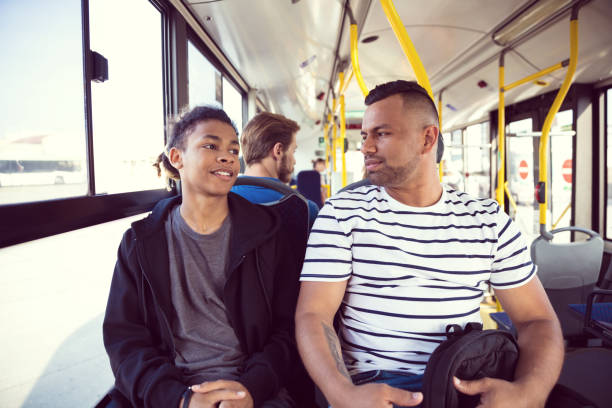 padre y adolescente viajando en autobús - front view bus photography day fotografías e imágenes de stock