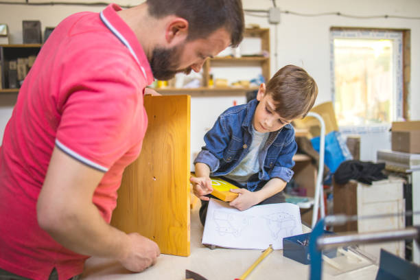 istock Father ad son building bird house 1223390155