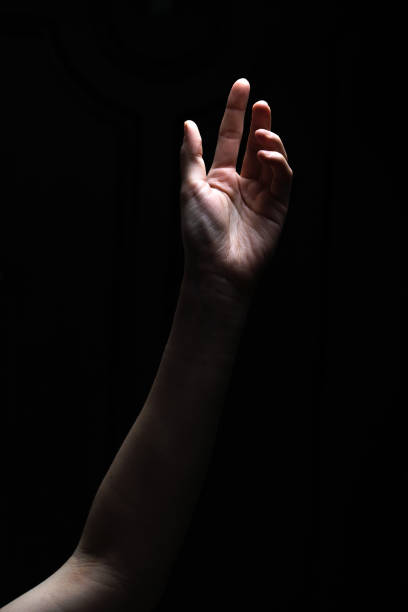 istock Female hand reaches for the light 1223390938